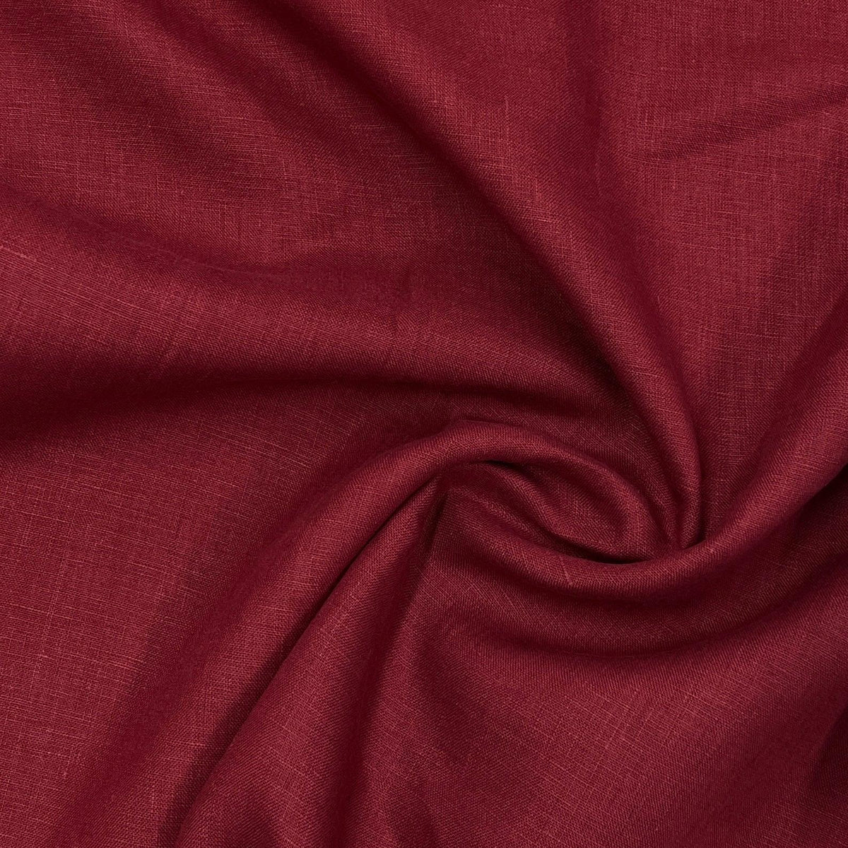 Nature's Fabrics burgundy red natural linen fabric swirled in a soft drape