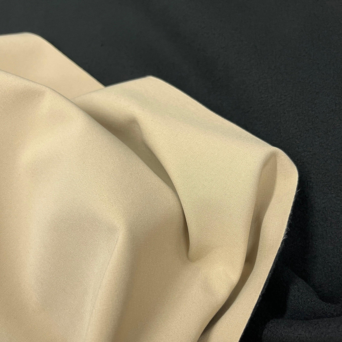 Close-up of draped beige premium natural fabric from Nature's Fabrics.