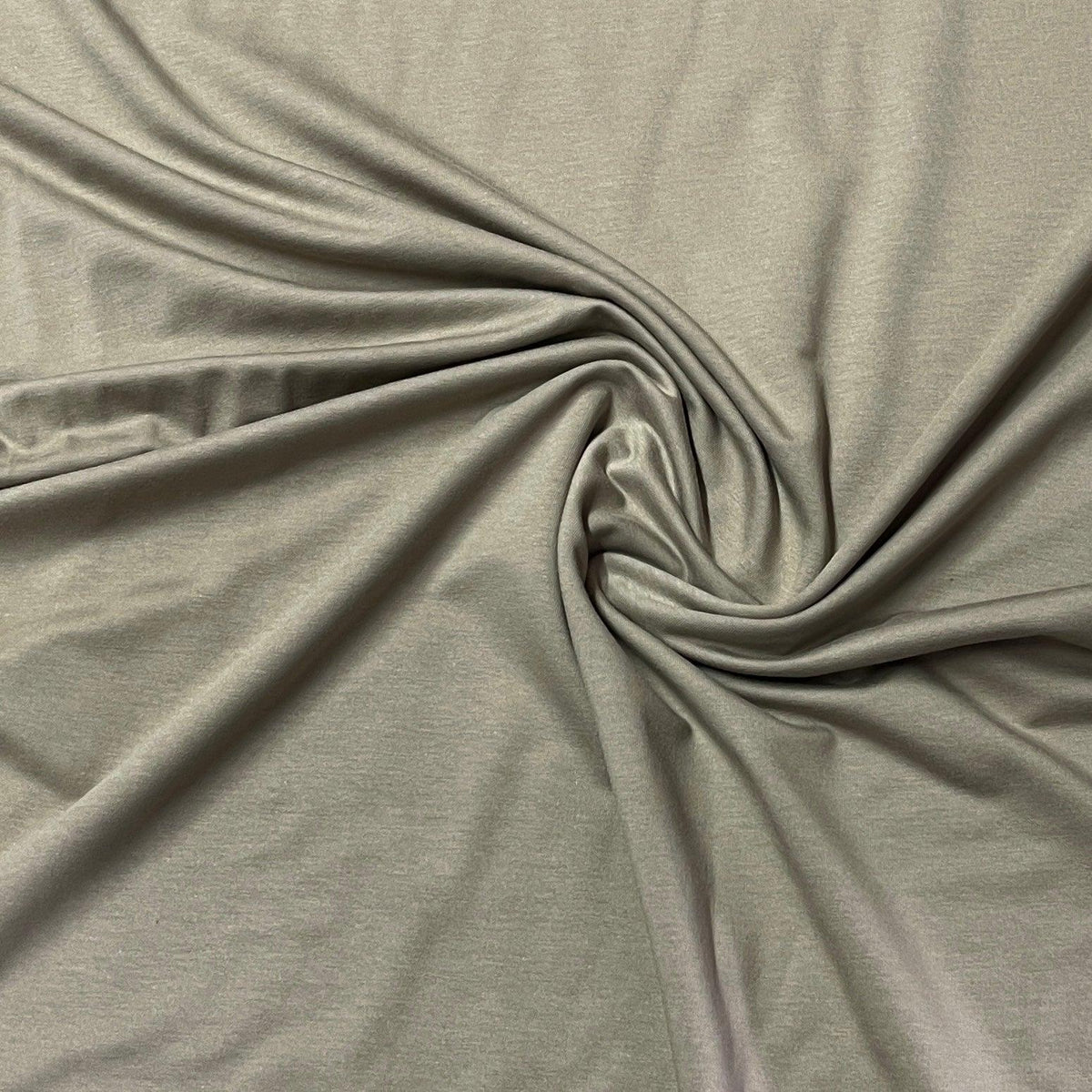 Nature's Fabrics grey natural fabric draped in a spiral pattern
