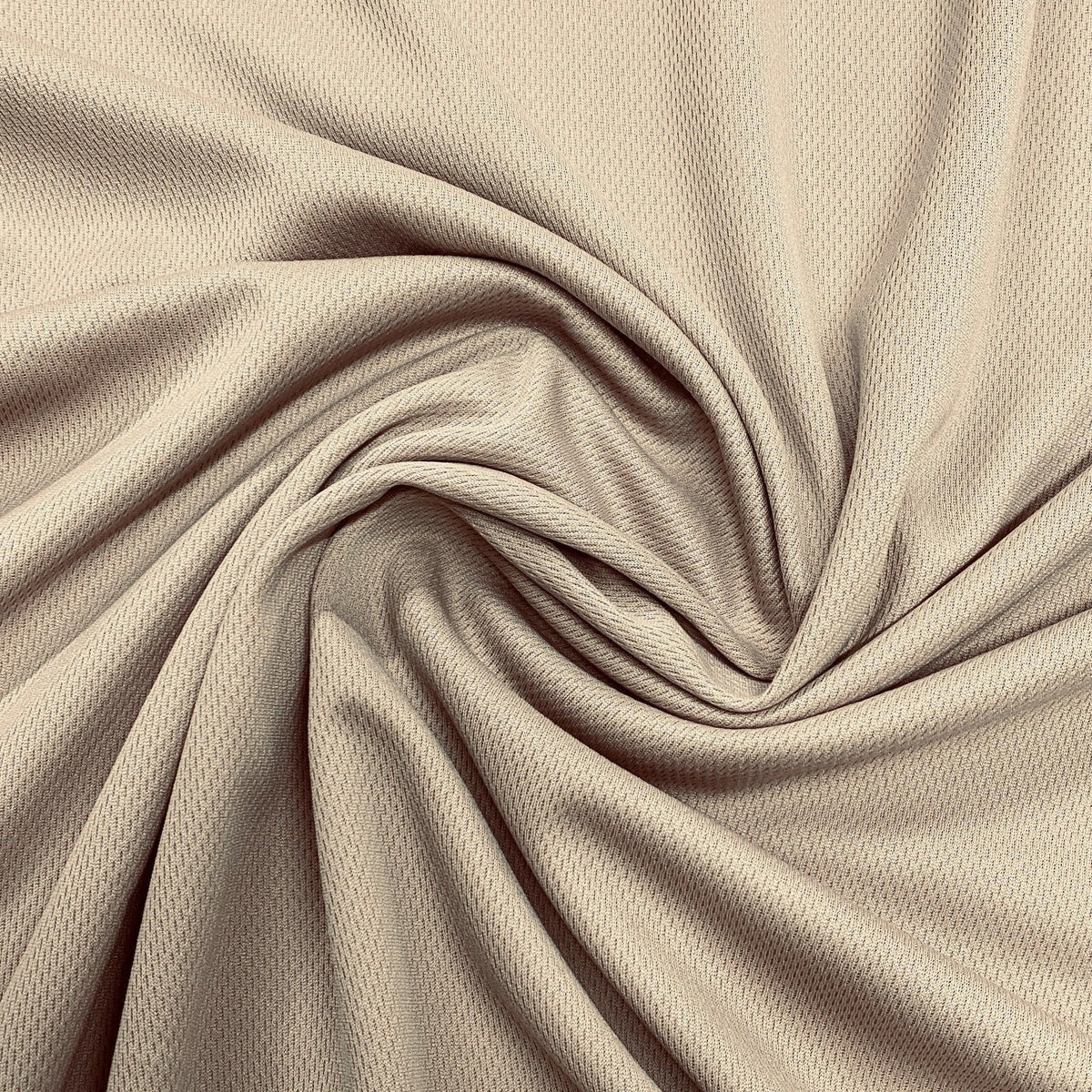Nature's Fabrics beige textured fabric with elegant swirls and drapes.