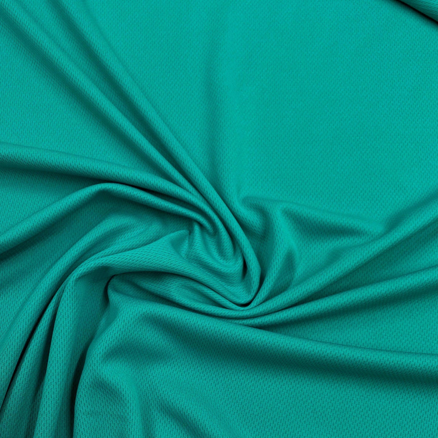Close-up of draped turquoise athletic mesh fabric from Nature's Fabrics.