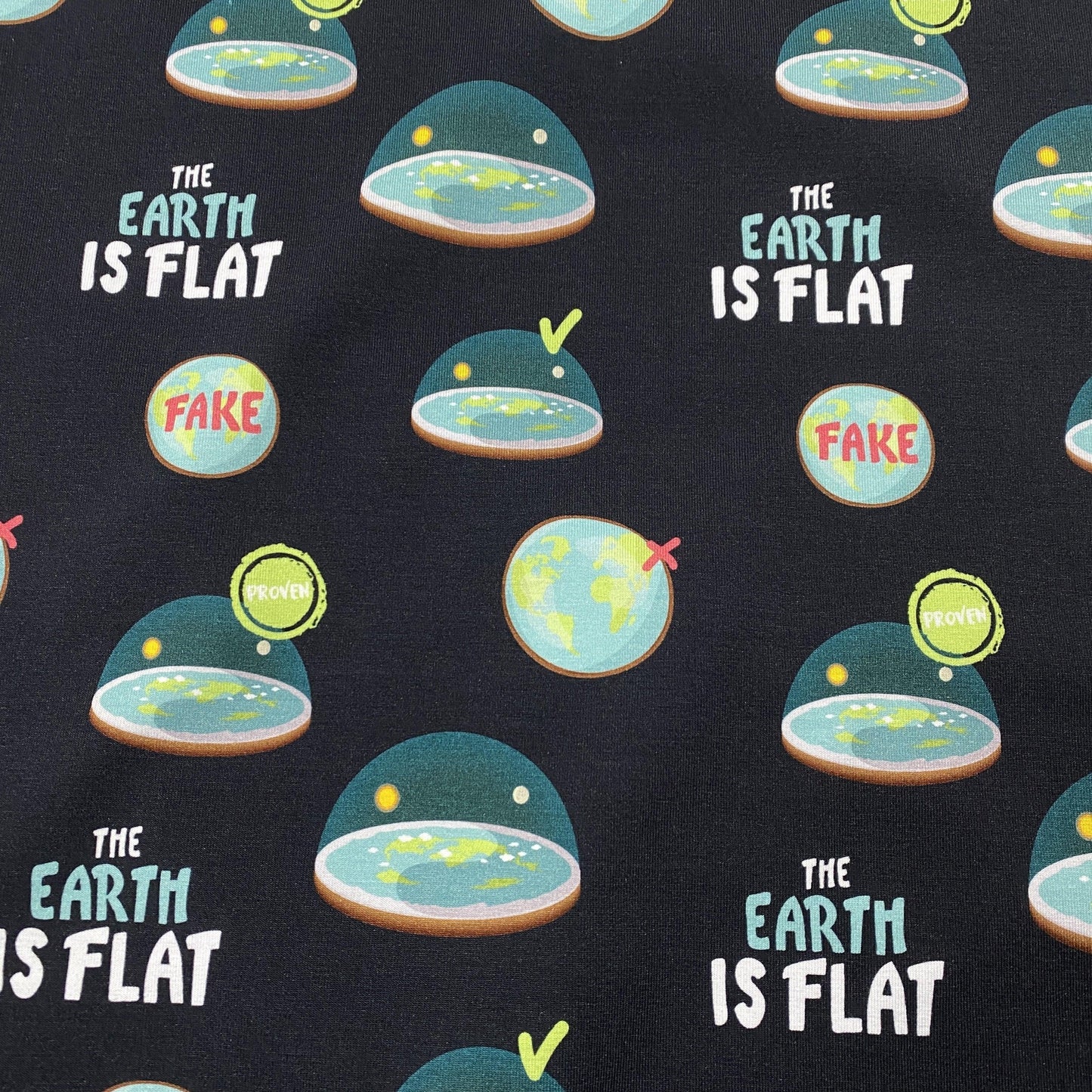 Nature's Fabrics black fabric with 'The Earth is Flat' text and flat earth illustrations.