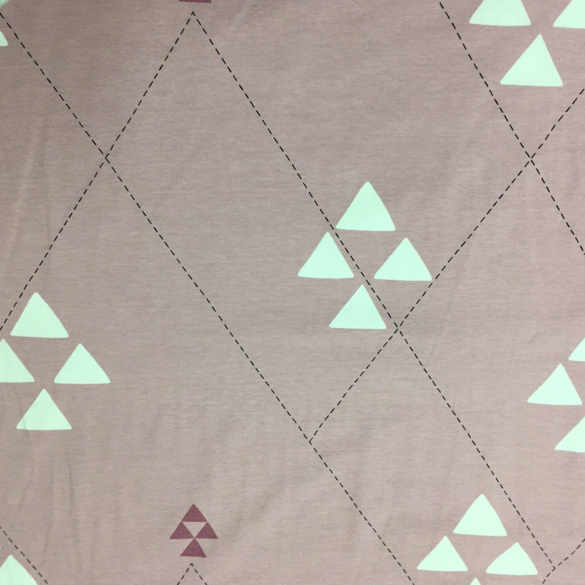 Nature's Fabrics dusty rose cotton fabric with white geometric triangle patterns