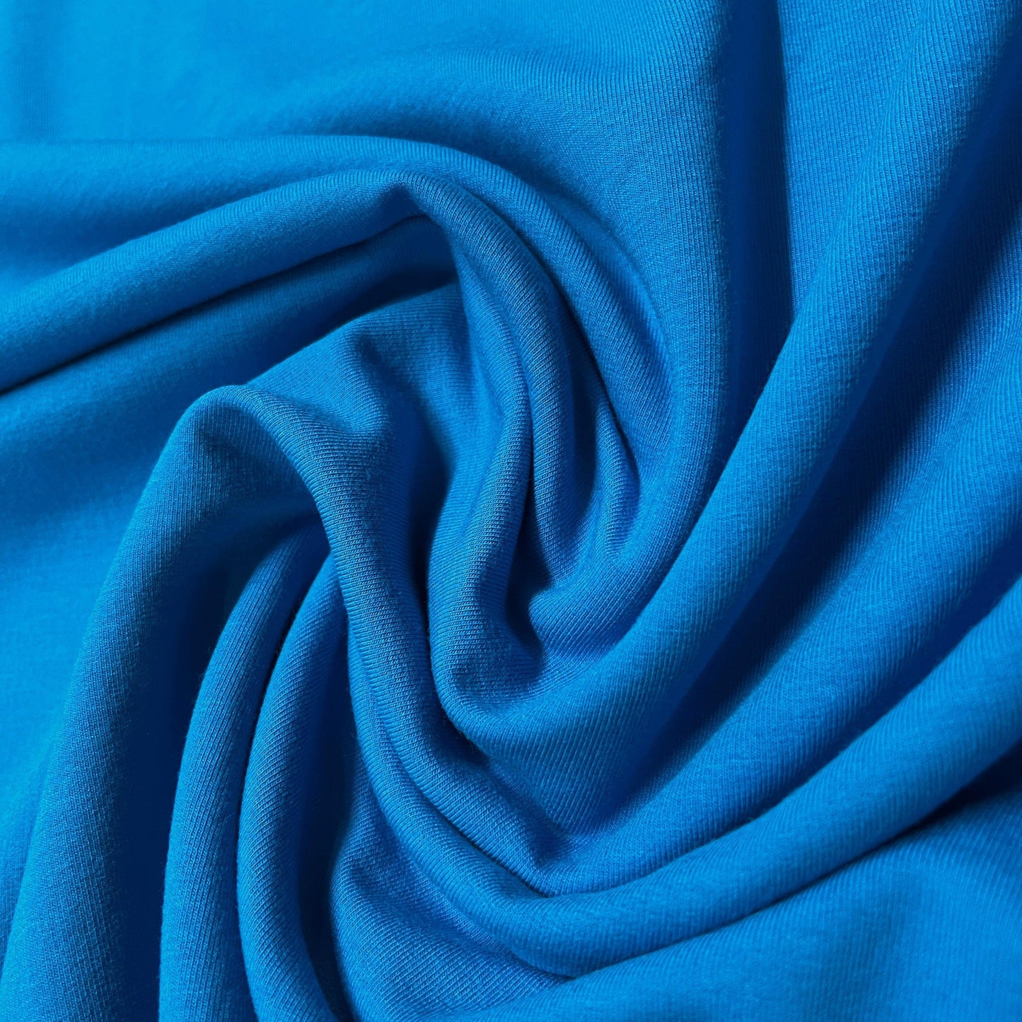 Close-up of draped royal blue organic cotton fabric from Nature's Fabrics
