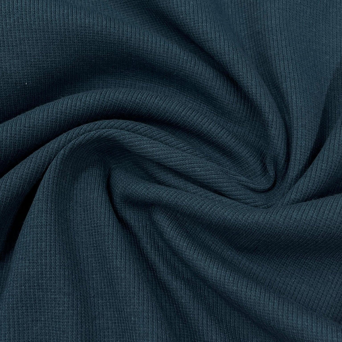 Close-up of draped navy blue ribbed natural fabric from Nature's Fabrics