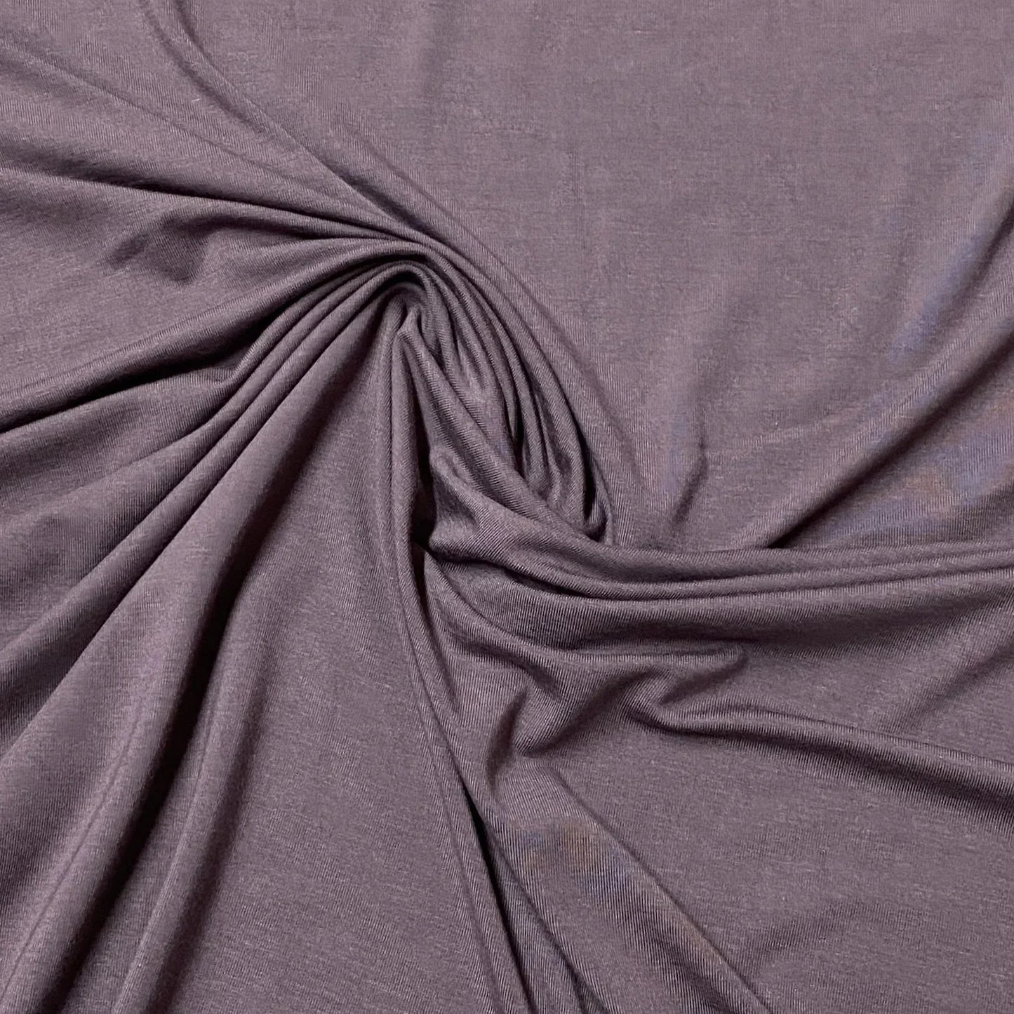 Nature's Fabrics purple organic fabric draped in a soft swirl