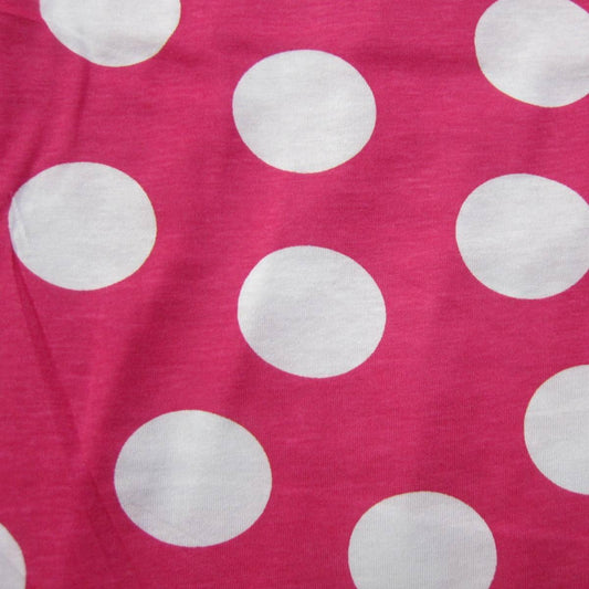 Pink fabric with large white polka dots from Nature's Fabrics