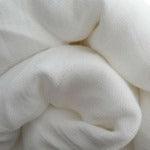 Close-up of soft, draped white organic cotton fabric from Nature's Fabrics.