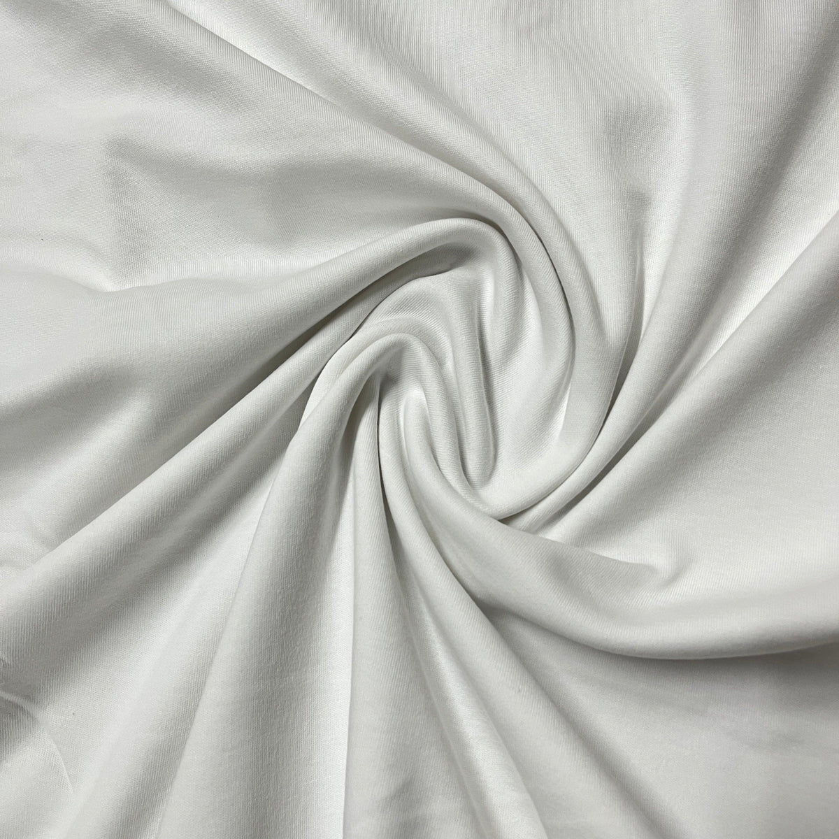 Close-up of draped white organic cotton fabric from Nature's Fabrics.