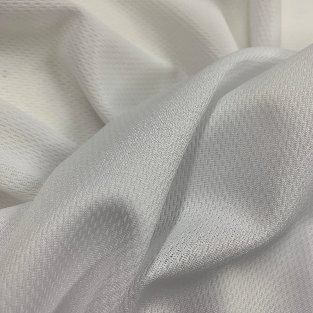 Close-up of draped white textured natural fabric from Nature's Fabrics