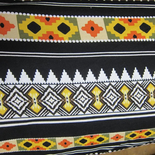 Nature's Fabrics black fabric with colorful geometric tribal patterns in yellow, orange, and white