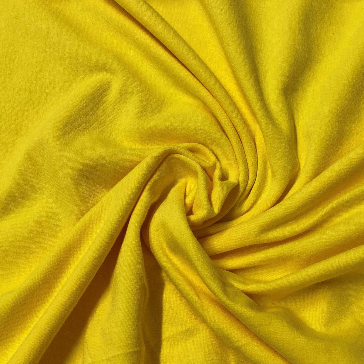 Swirled bright yellow organic cotton fabric from Nature's Fabrics