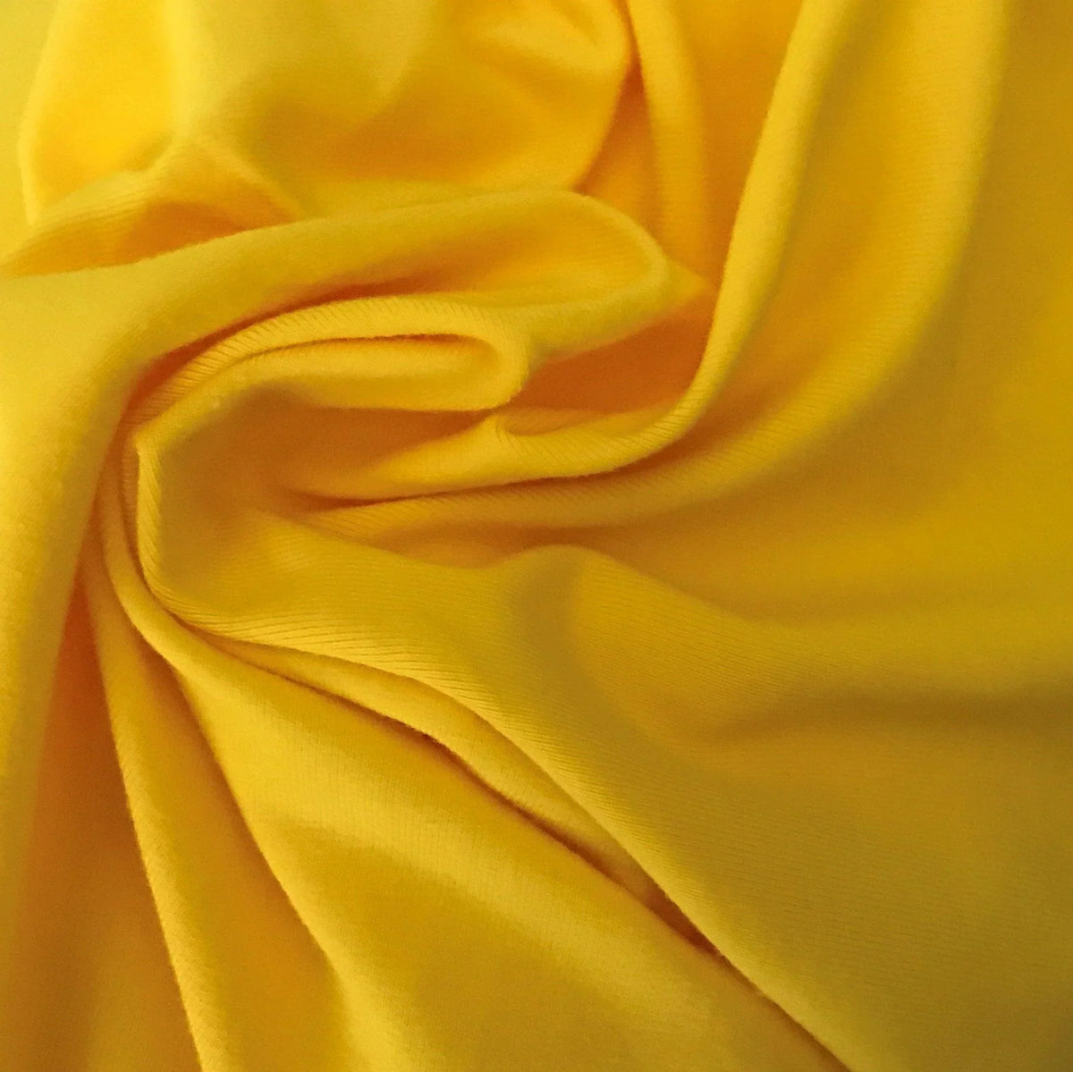 Close-up of draped yellow organic cotton fabric from Nature's Fabrics