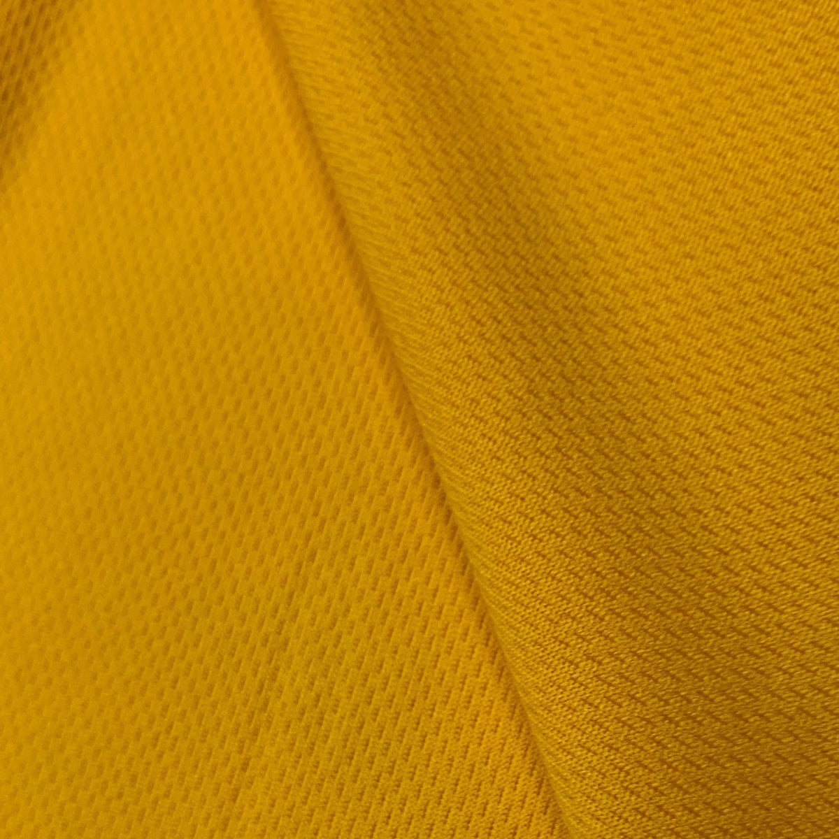 Close-up of yellow textured natural fabric from Nature's Fabrics.