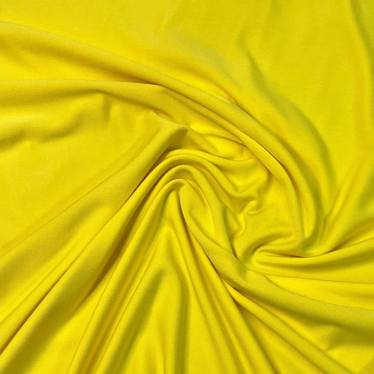 Nature's Fabrics bright yellow draped natural fabric with soft folds