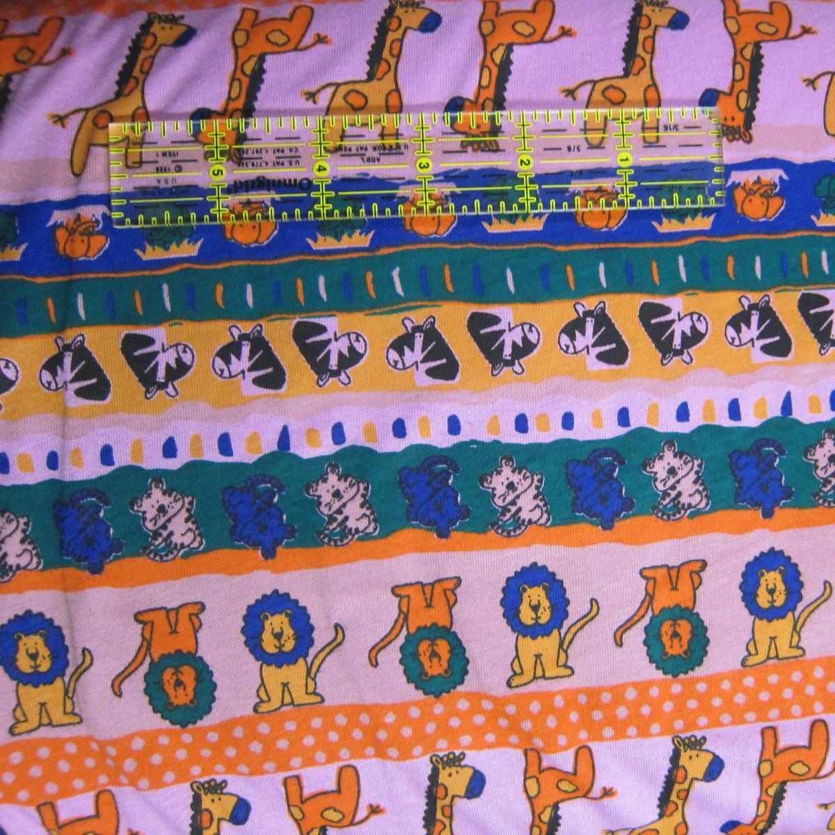 Nature's Fabrics colorful animal print fabric featuring giraffes, lions, and zebras.