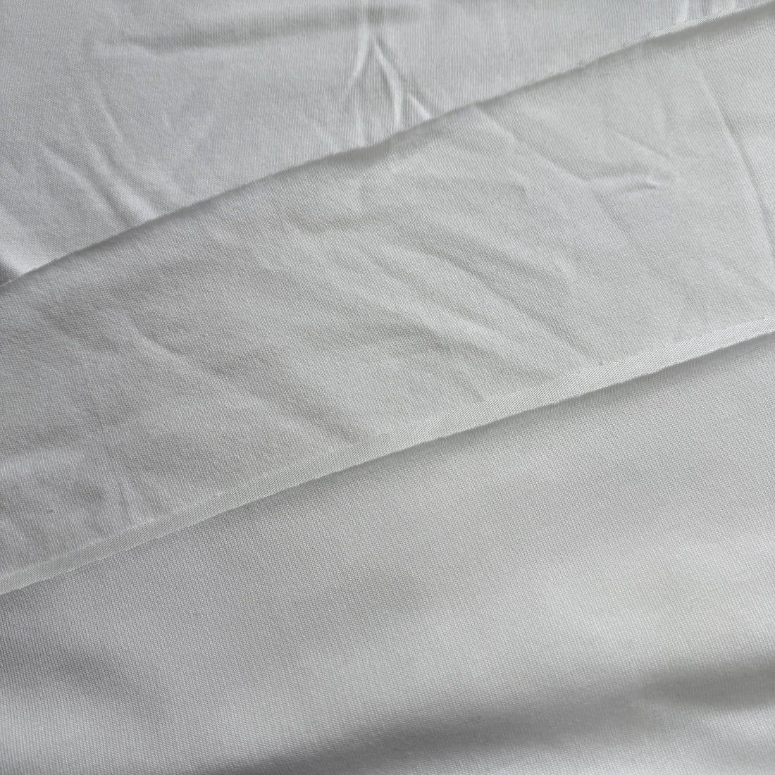 Close-up of bamboo jersey and cotton jersey white fabric texture comparison.