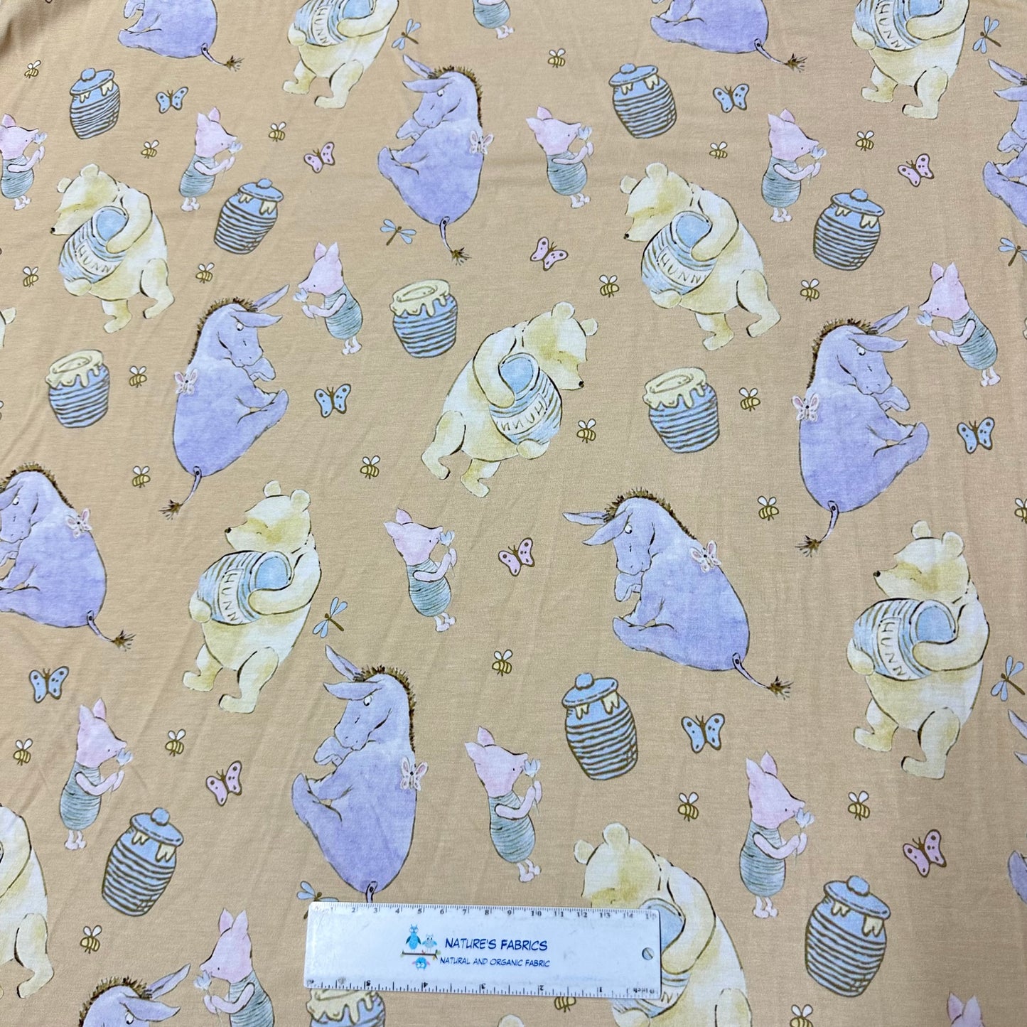 Winnie the Pooh and Friends on Gold Bamboo/Spandex Jersey Fabric