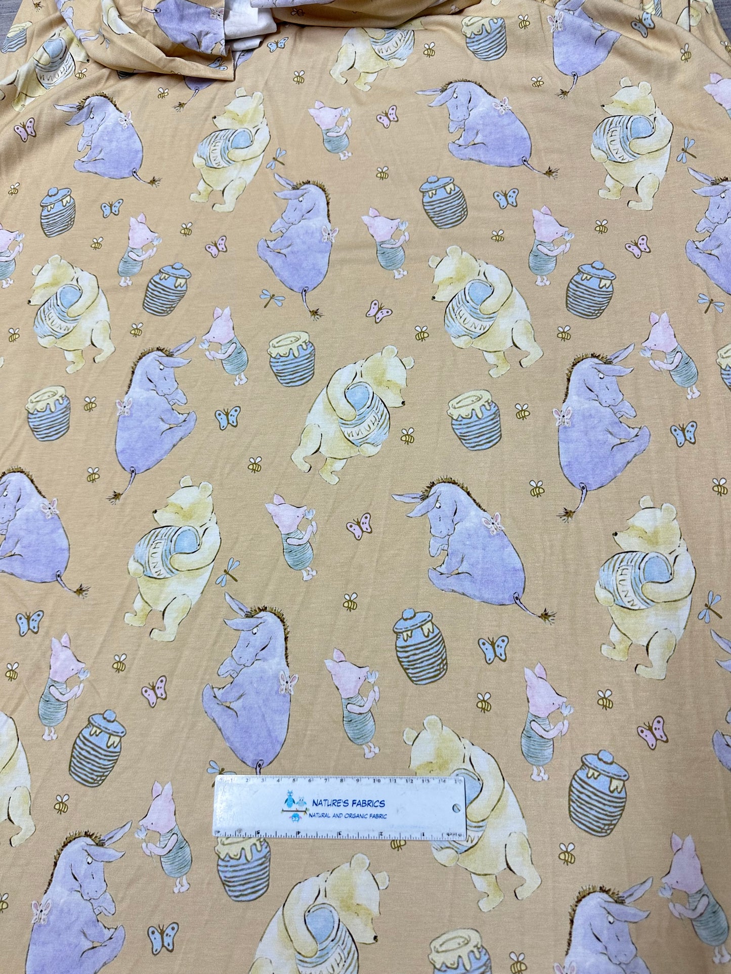 Winnie the Pooh and Friends on Gold Bamboo/Spandex Jersey Fabric