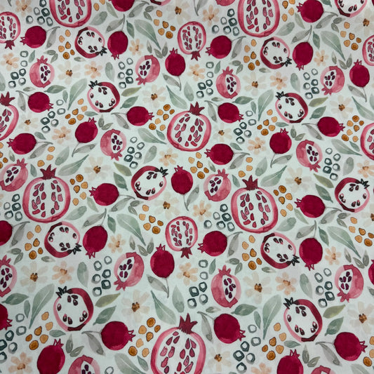 Pomegranate print organic cotton fabric by Nature's Fabrics, featuring vibrant red fruit and green leaves