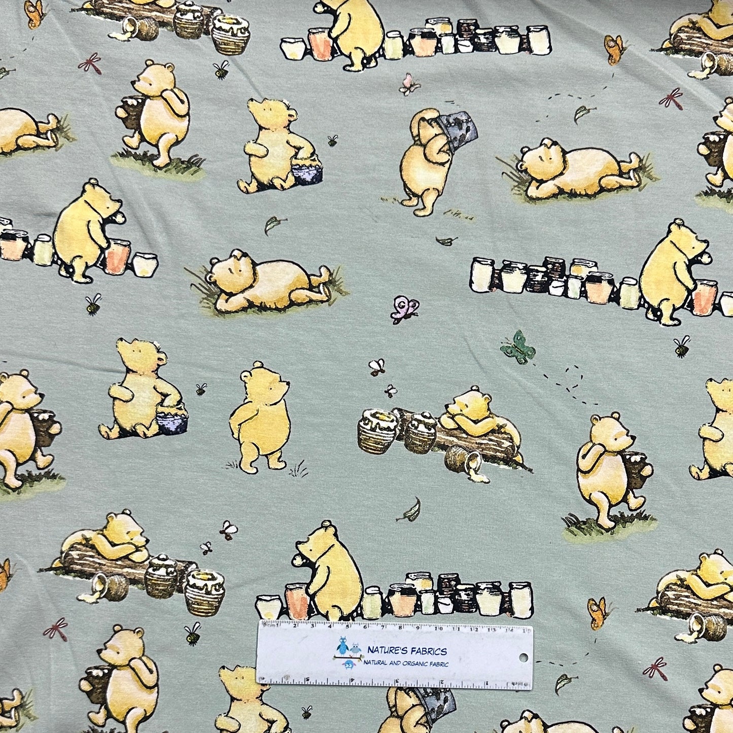 Winnie the Pooh and Honey Pots on Green Organic Cotton/Spandex Jersey Fabric