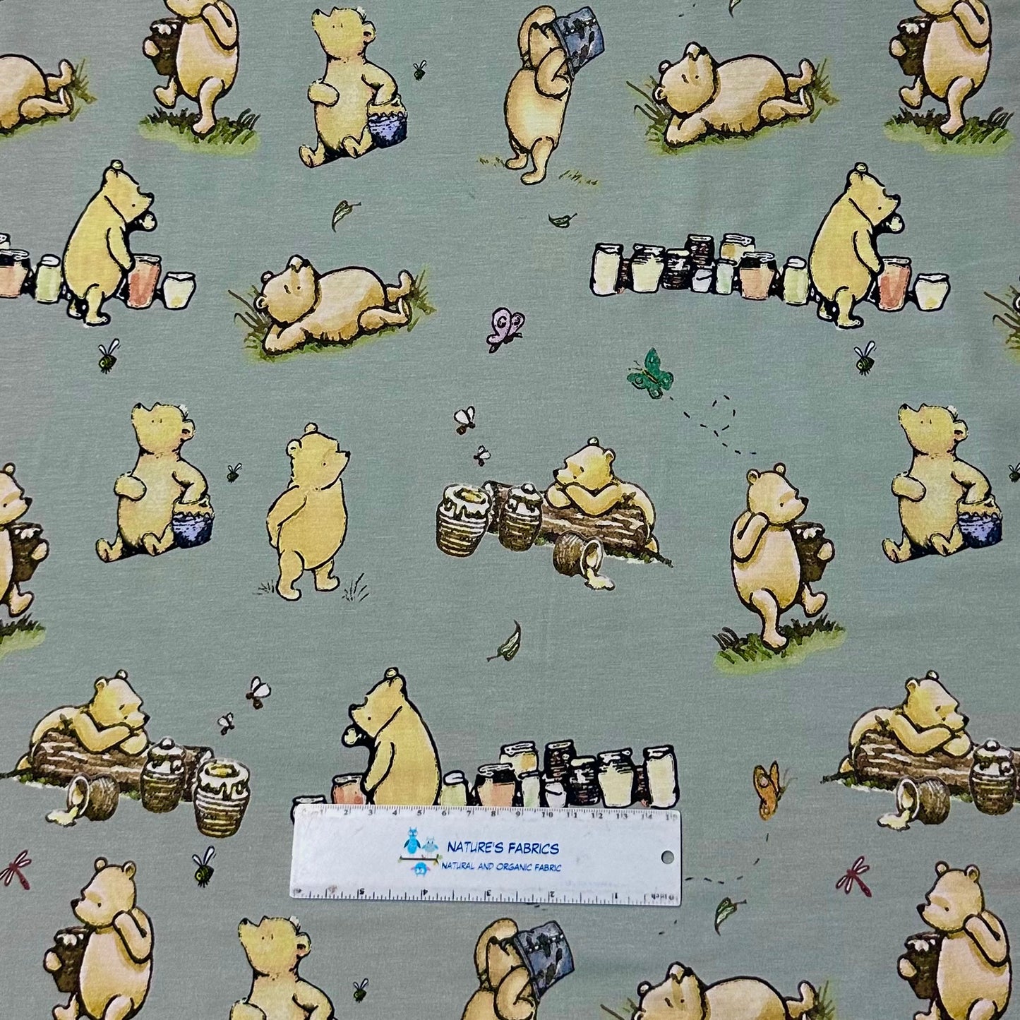 Winnie the Pooh and Honey Pots on Green Bamboo/Spandex Jersey Fabric