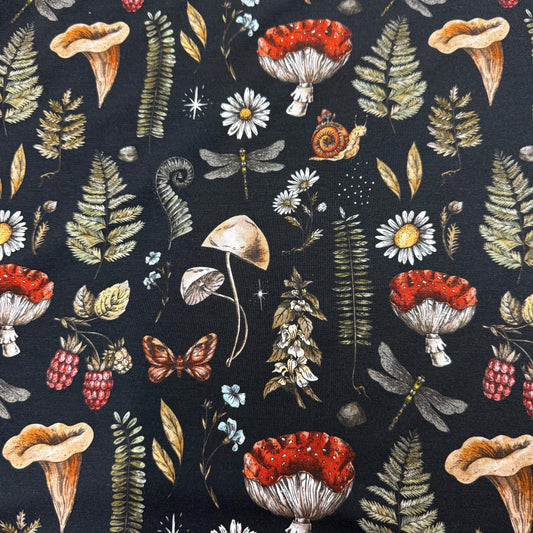 Nature's Fabrics mushroom and fern print fabric with daisies, raspberries, and butterflies on dark background