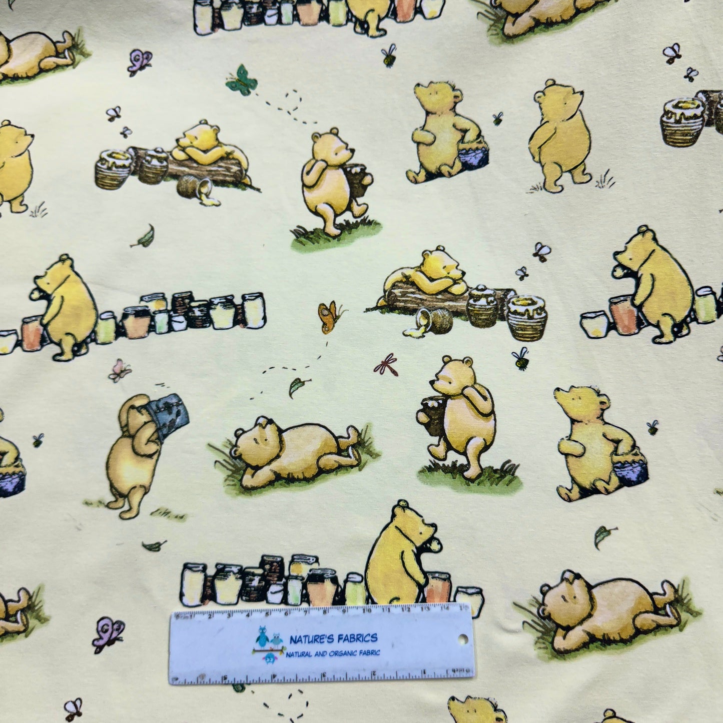 Winnie the Pooh and Honey Pots on Cream Organic Cotton/Spandex Jersey Fabric