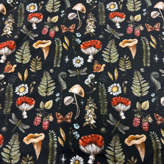 Nature's Fabrics mushroom, fern, and berry print on black cotton fabric