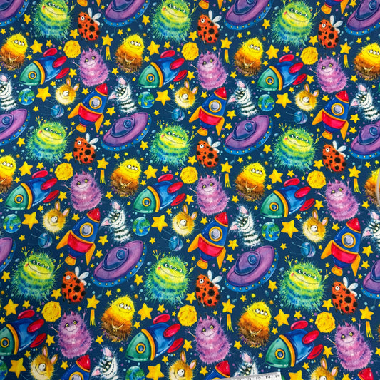 Colorful space-themed fabric with aliens, rockets, and stars by Nature's Fabrics