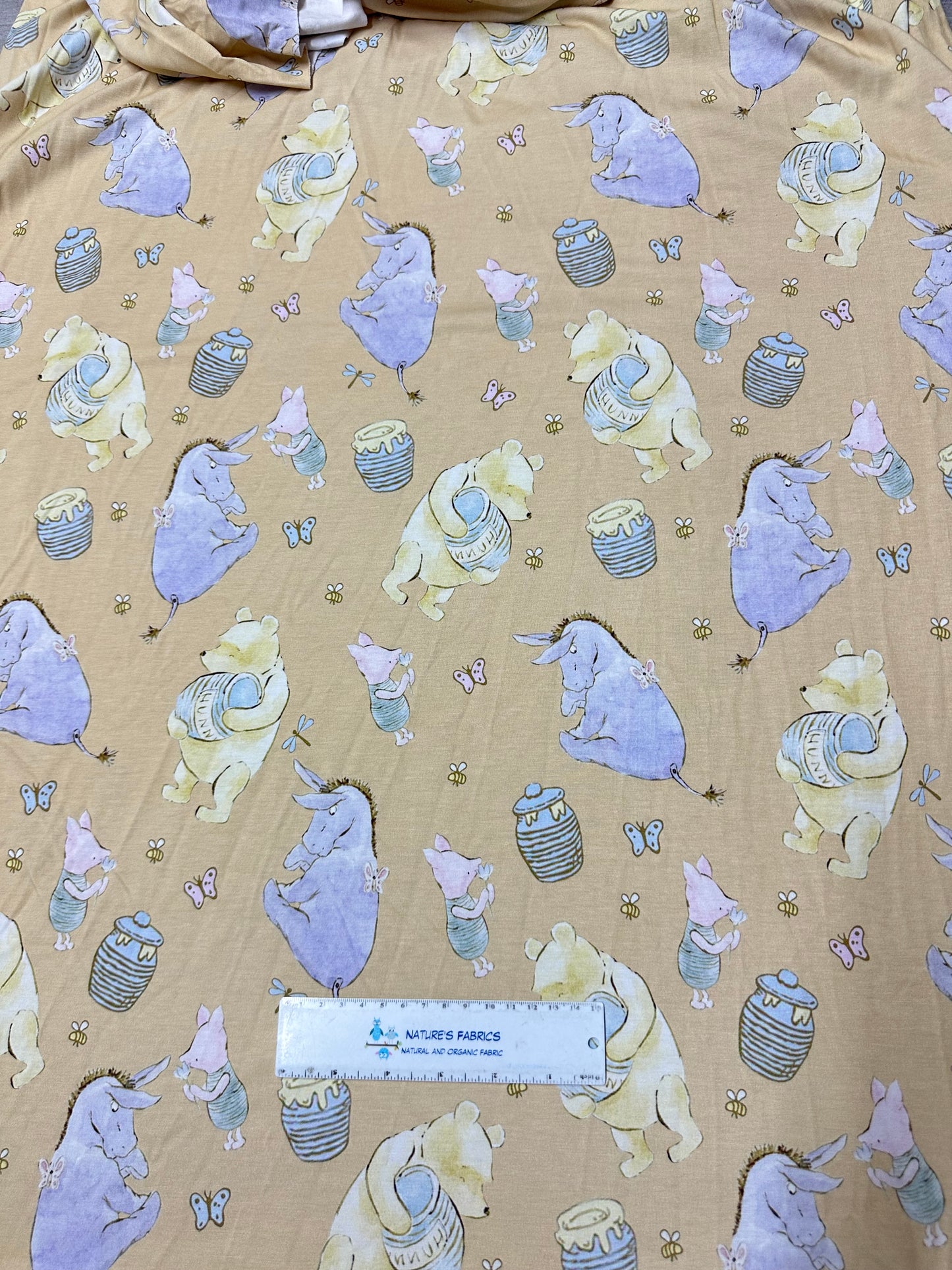 Winnie the Pooh and Friends on Gold Bamboo/Spandex Jersey Fabric