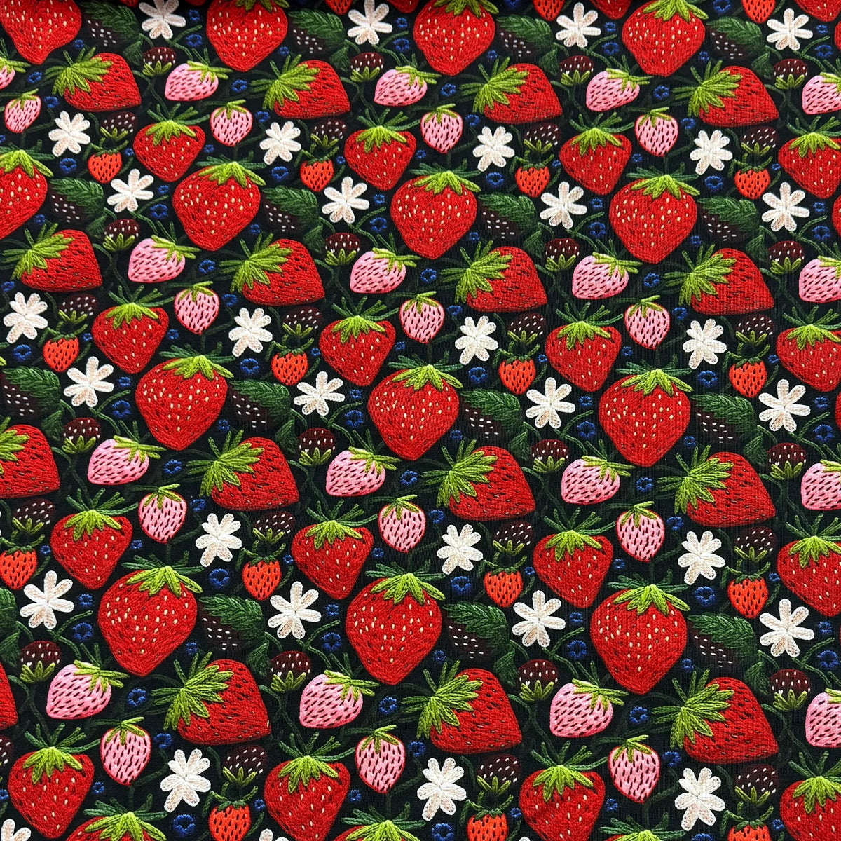 Strawberry print fabric by Nature's Fabrics — red, pink berries with white flowers on dark background