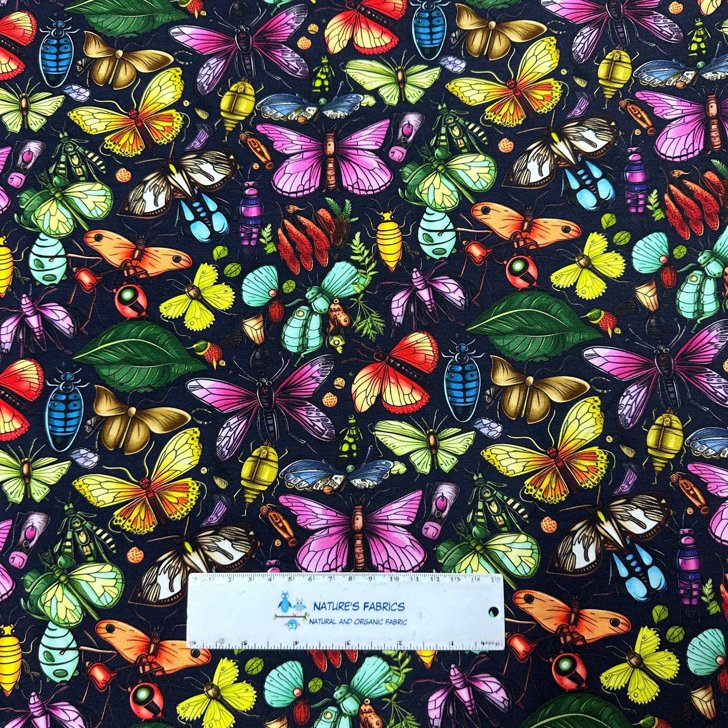 Colorful Bugs on Black Bamboo/Spandex Jersey Fabric - Nature's Fabrics