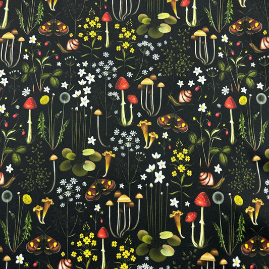 Nature's Fabrics botanical pattern with red mushrooms, snails, and wildflowers on black background