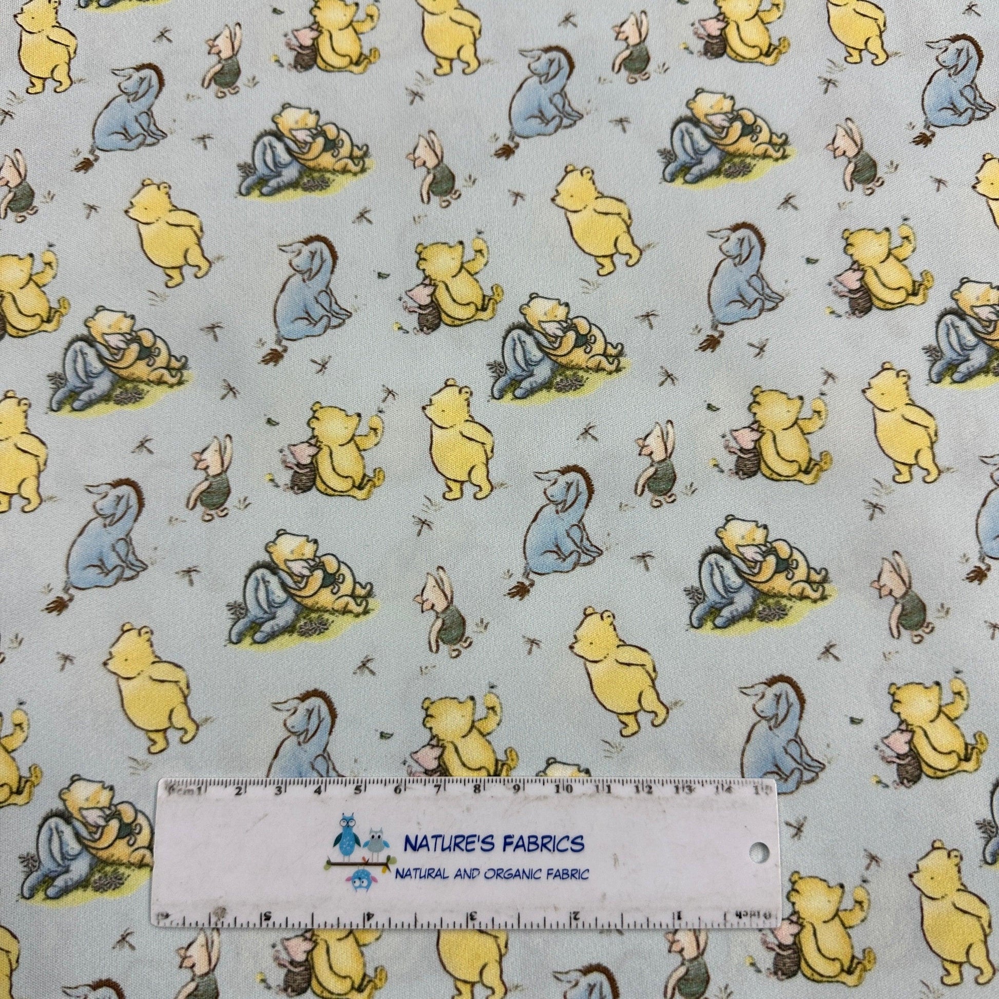 Winnie the Pooh and Friends on Blue 1 mil PUL Fabric - Made in the USA - Nature's Fabrics