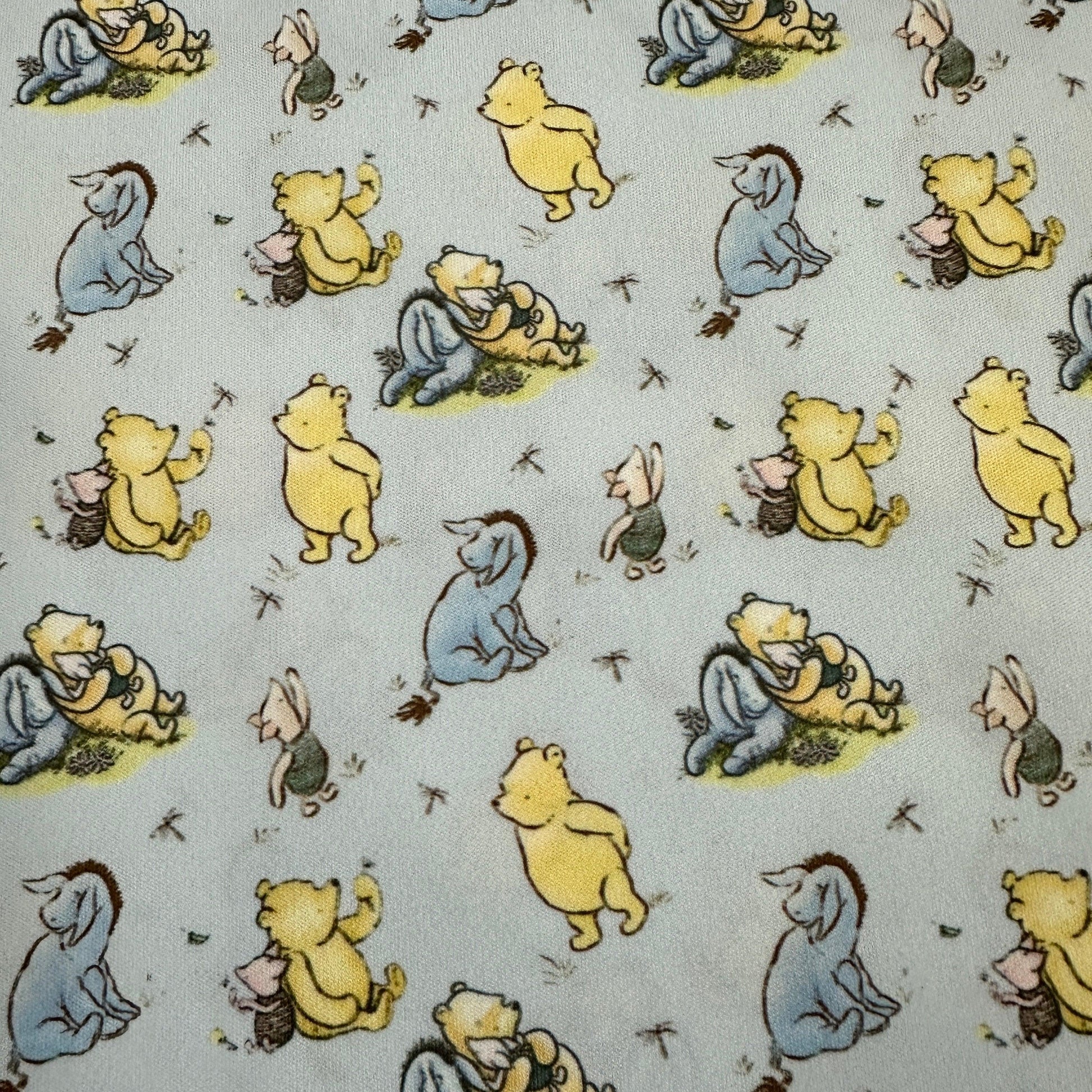 Winnie the Pooh and Friends on Blue 1 mil PUL Fabric - Made in the USA - Nature's Fabrics