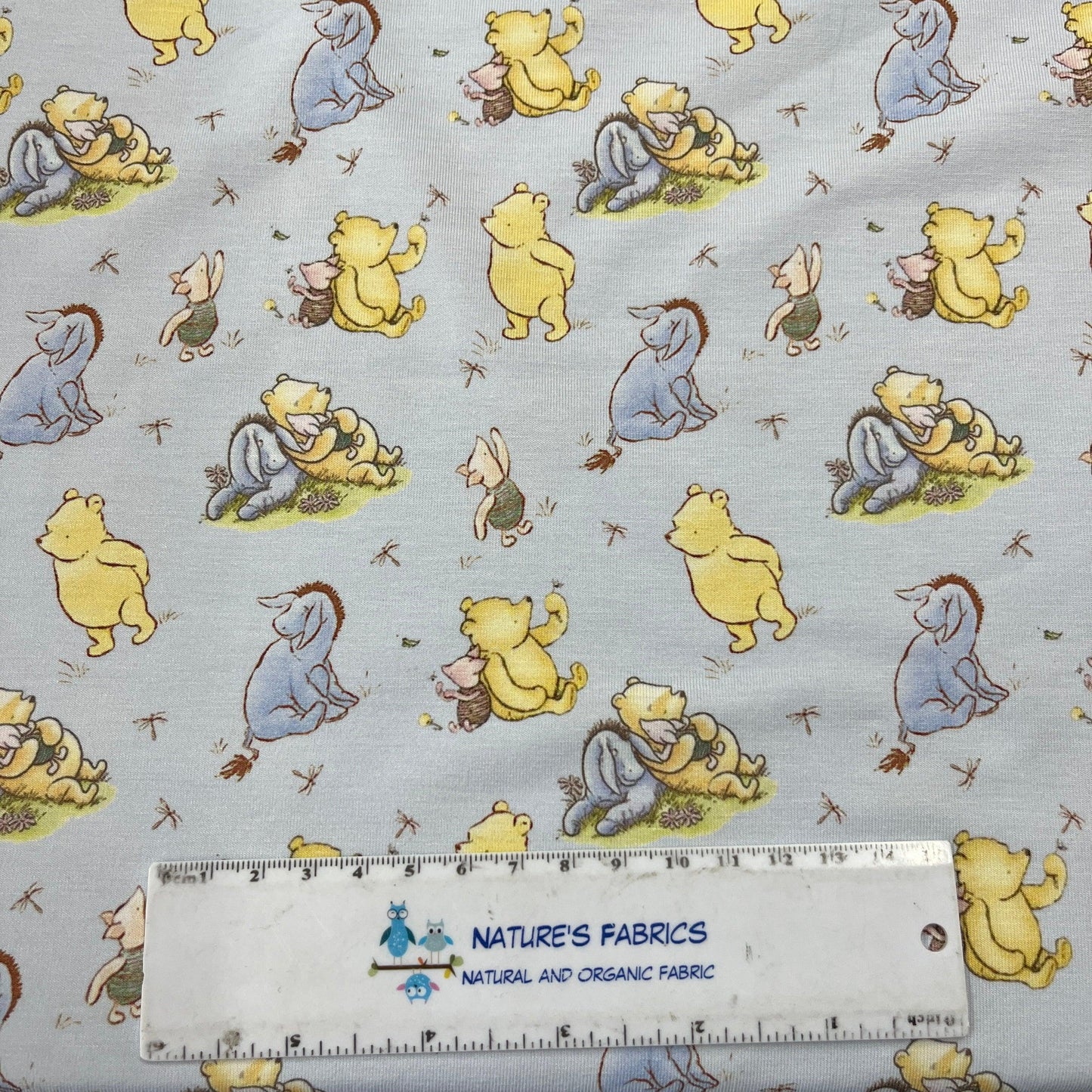 Winnie the Pooh and Friends on Blue Bamboo/Spandex Jersey Fabric - Nature's Fabrics