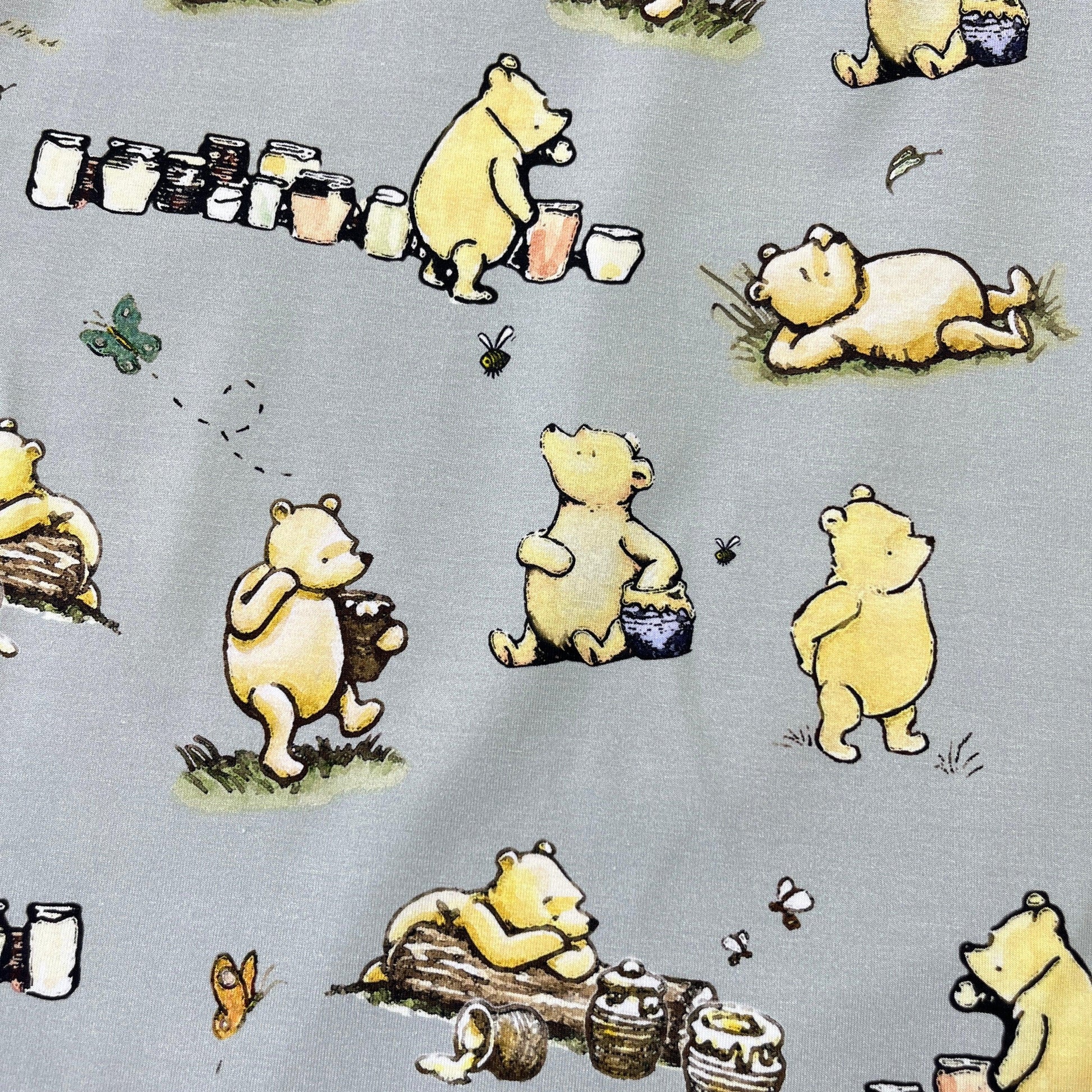 Winnie the Pooh and Honey Pots on Green Bamboo/Spandex Jersey Fabric - Nature's Fabrics