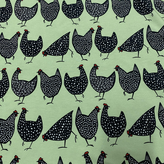 Nature's Fabrics light green fabric with a pattern of black and white dotted chickens