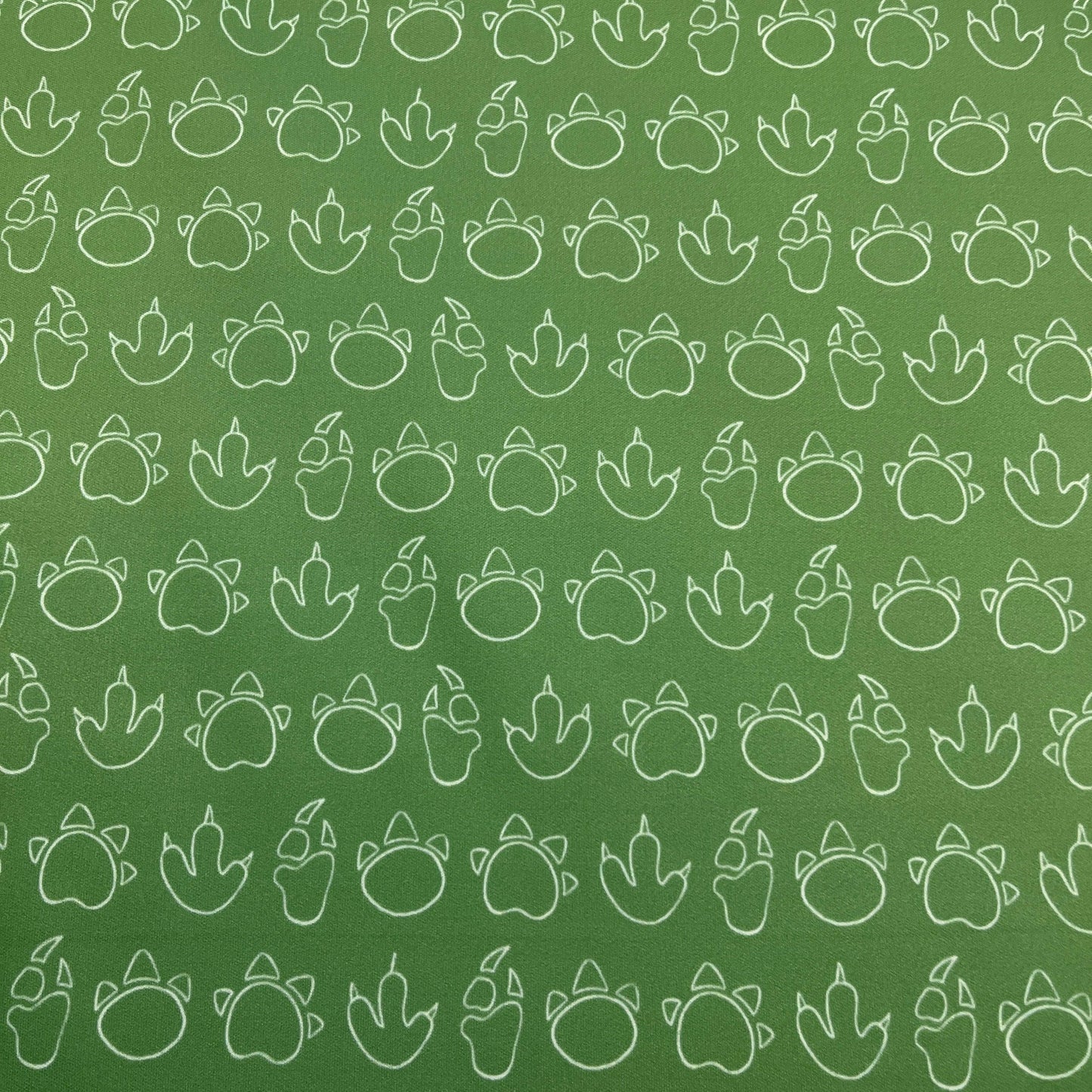 Dino Tracks on Green 1 mil PUL Fabric - Made in the USA - Nature's Fabrics