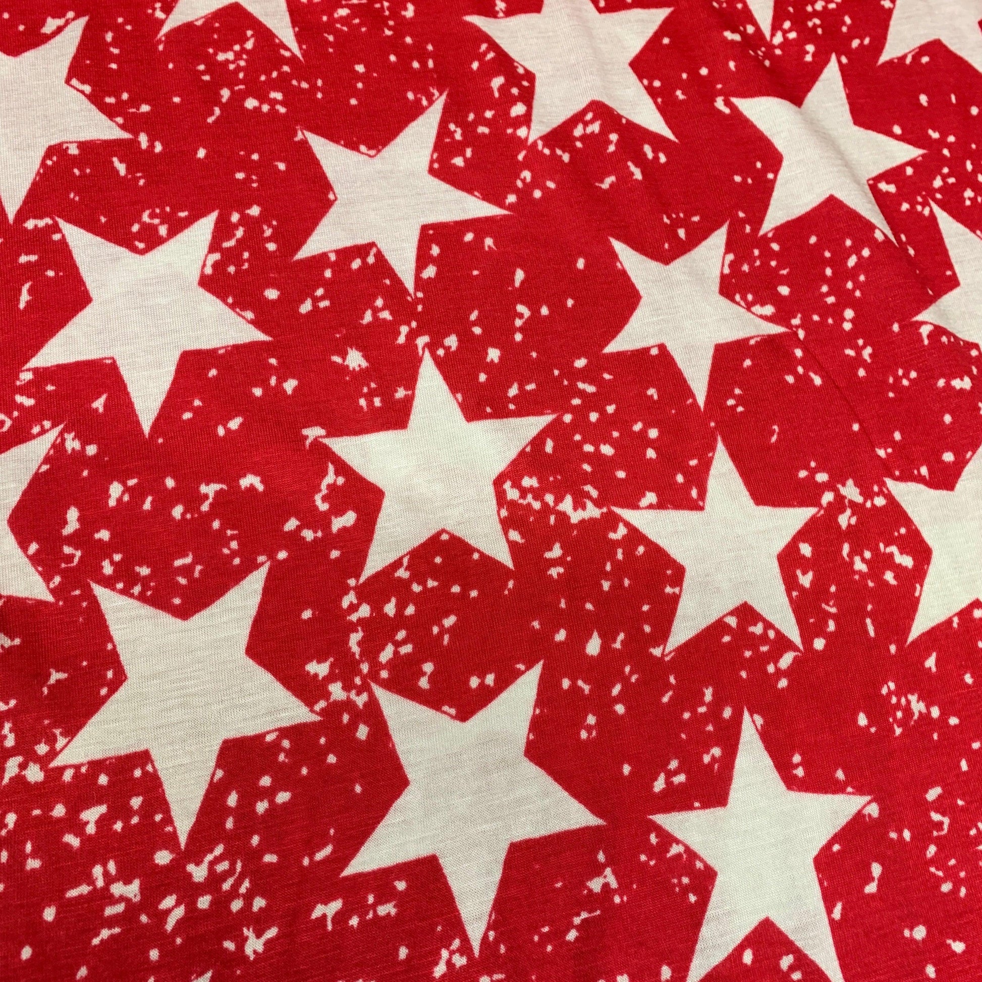 Distressed White Stars on Red Cotton/Poly Jersey Fabric - Nature's Fabrics