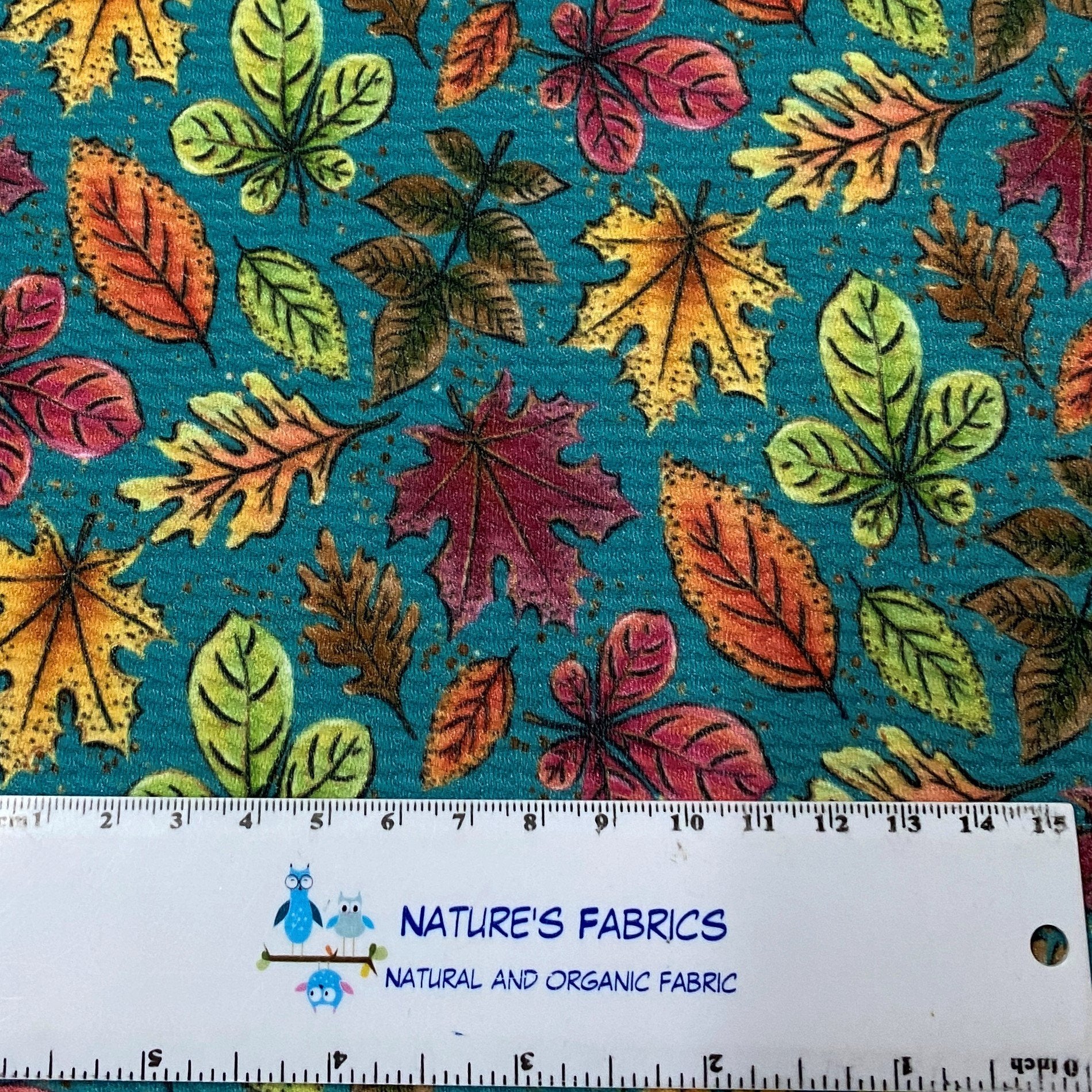 Fall Leaves on Teal Bullet Knit - Nature's Fabrics