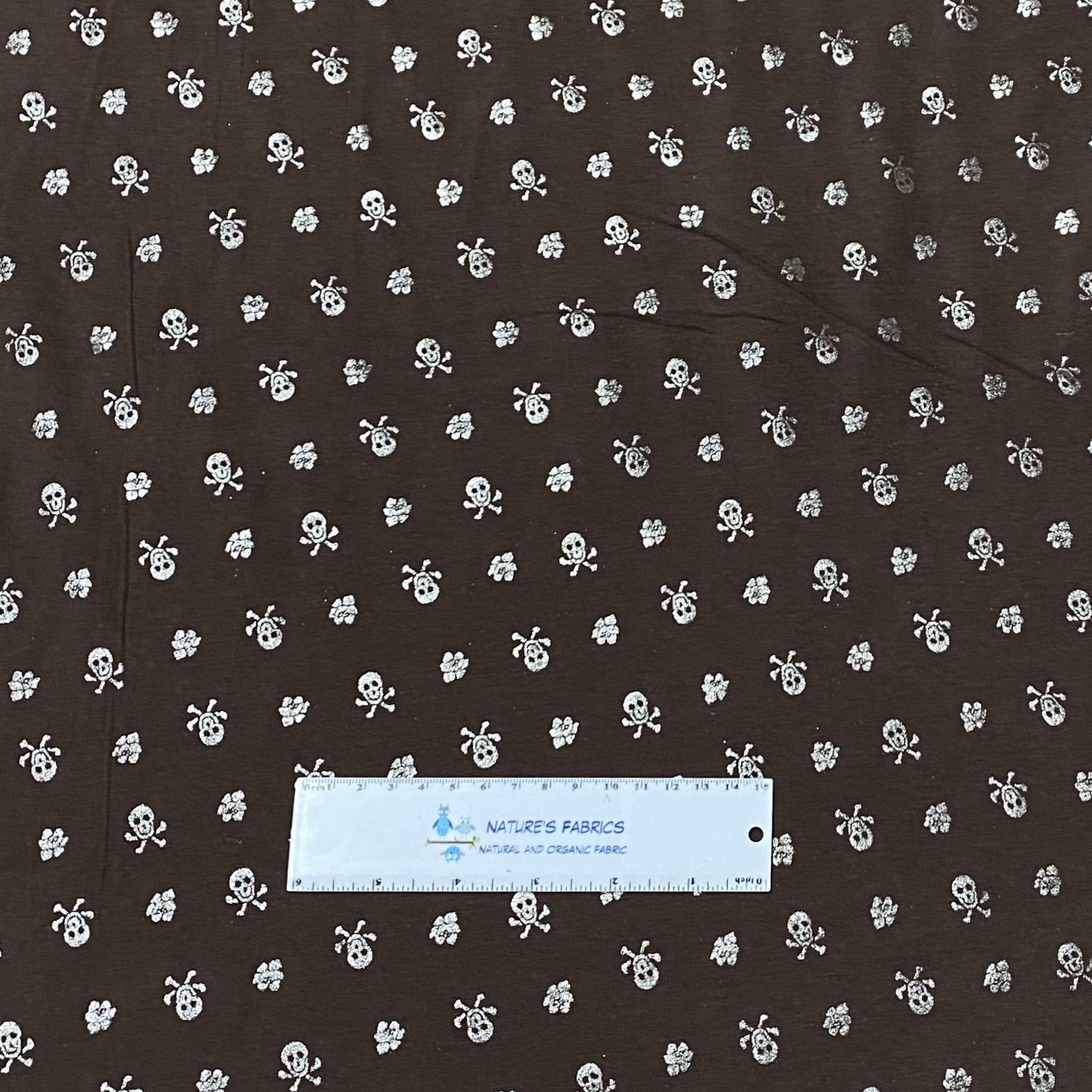 Silver Skulls on Brown Cotton/Spandex Jersey Fabric - Nature's Fabrics