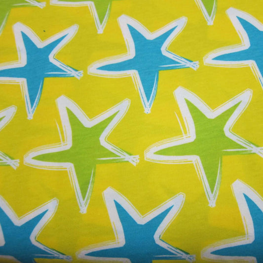 Summer Stars on Yellow Cotton Jersey Fabric - Nature's Fabrics