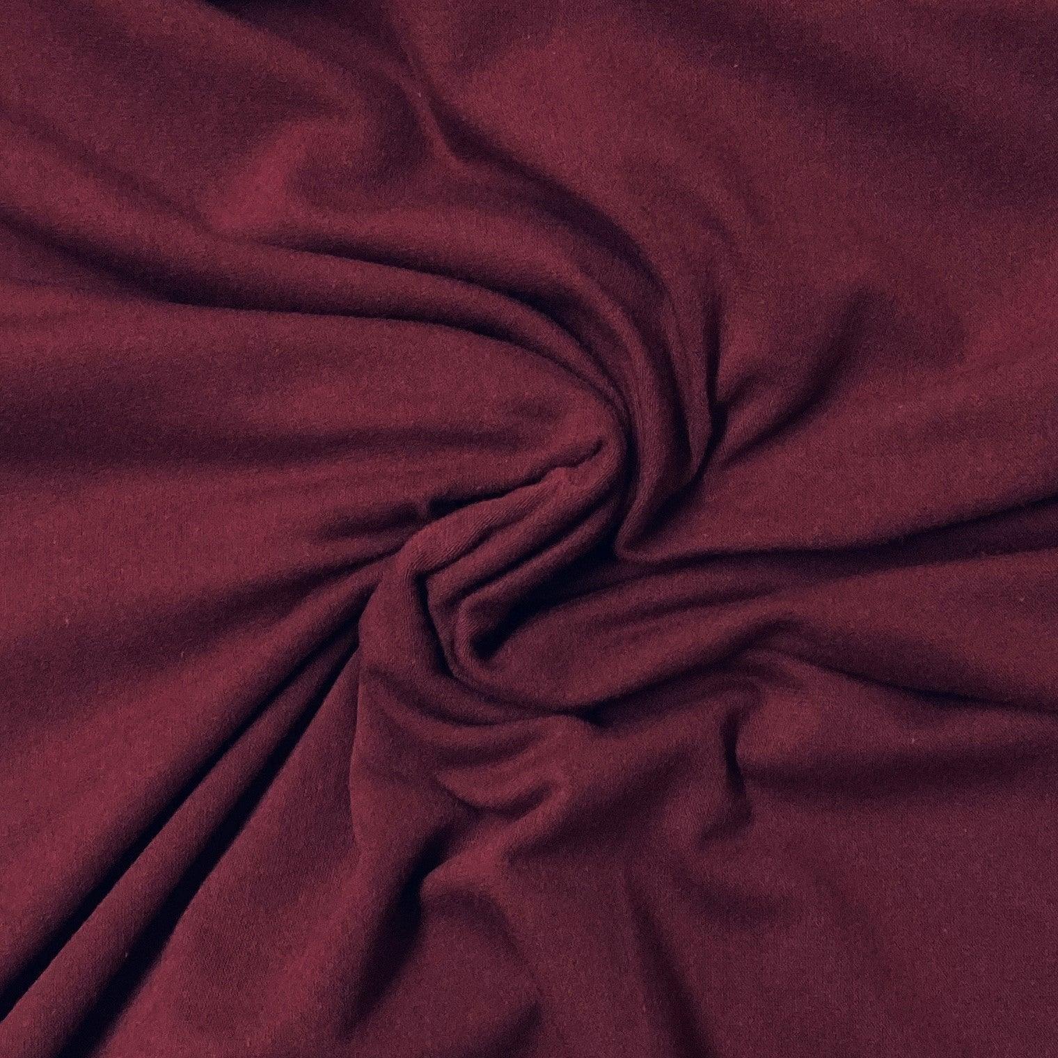 Deep burgundy premium natural fabric from Nature's Fabrics draped in soft folds.